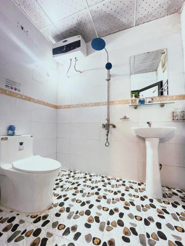 a bathroom with a toilet and a sink at Vani's Home in Ninh Binh