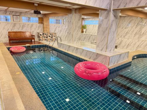 a swimming pool with a red frisbee in it at Angel Pool Villa Phuket - SHA Extra Plus in Phuket Town