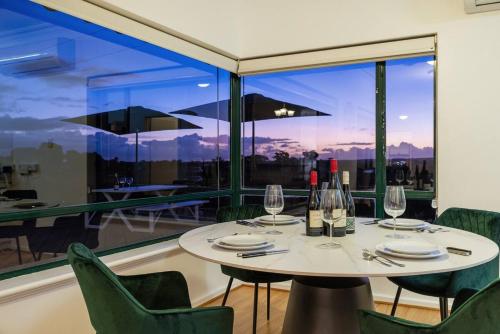 a dining room with a table and chairs and a large window at McGill Vineyard Barossa in Lights Pass