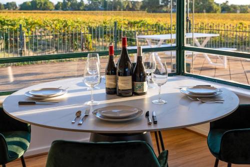a table with two bottles of wine and glasses at McGill Vineyard Barossa in Lights Pass