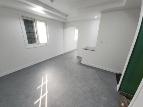 an empty room with white walls and a window at Moneystay Daegu Palgongsan in Daegu