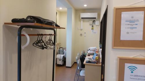 a hospital room with a table and chairs in a room at 日本ワインバックパッカーズ in Tokyo
