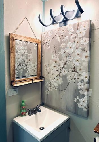 a bathroom with a sink and a mirror at Cabin Getaway with Lake View! in Coeur d'Alene