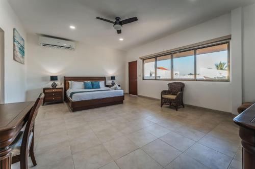 a bedroom with a bed and a table and chair at Casa Ceballos, Frente a la Playa in San Benito