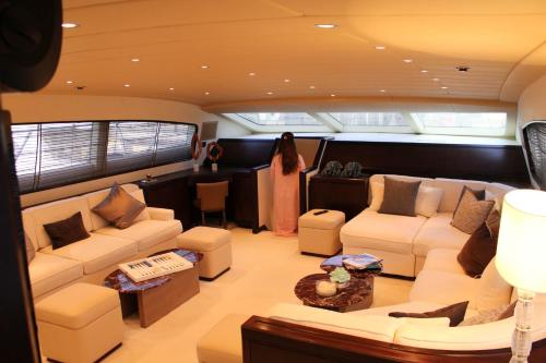 a large living room with couches and tables at 105 ft Yacht in Mýkonos City
