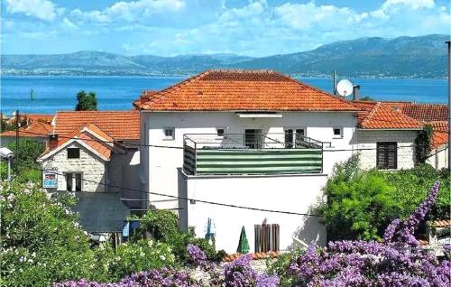 a white house with a red roof at Cozy Apartment In Supetar in Supetar