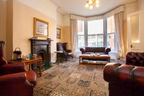 a living room with a couch and a fireplace at The Camberley in Harrogate
