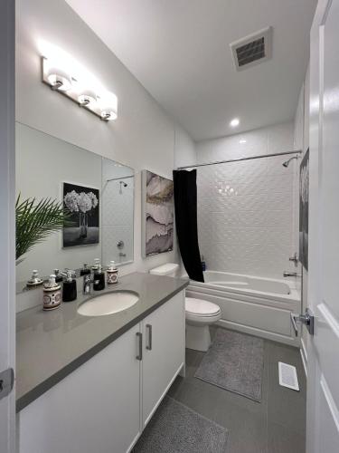 a white bathroom with a sink and a toilet at French Style Mansion In Prestigious Angus Glen Markham in Markham