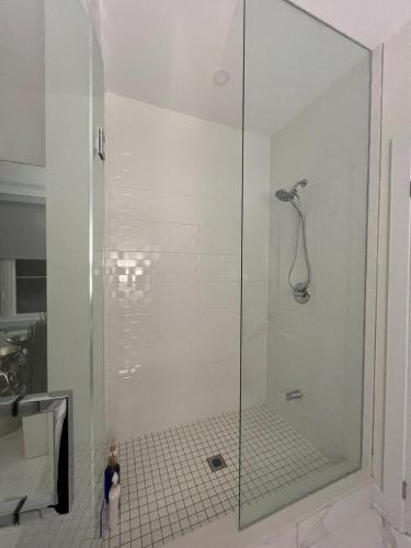 a shower with a glass door in a bathroom at French Style Mansion In Prestigious Angus Glen Markham in Markham