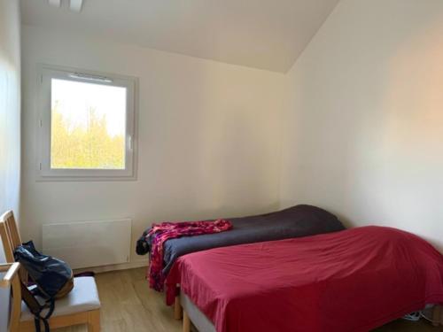 - une chambre avec un lit rouge et une fenêtre dans l'établissement Appartement neuf avec terrasse et parking à Groix - FR-1-813-23, à Groix