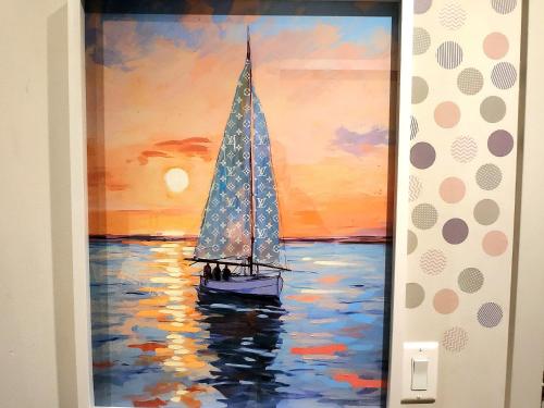 a painting of a sail boat in the water at Luxurious Downtown condo with spectacular views in Calgary