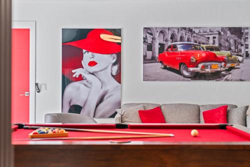 a living room with a red pool table and pictures at Perfect Location House in Miami Pool & Jacuzzi L43 in Miami
