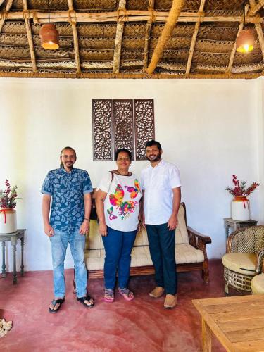 three men and a woman standing in a room at Santa Maria - A Premium Boutique Homestay by the Sea I Trivandrum Airport 1mile in Trivandrum