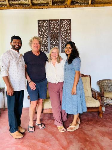 a group of people standing in front of a couch at Santa Maria - A Premium Boutique Homestay by the Sea I Trivandrum Airport 1mile in Trivandrum