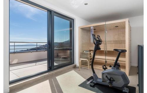 a room with a gym with a treadmill and a window at Casa Fani in Poljane