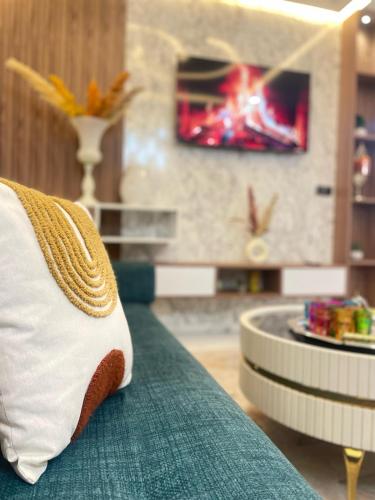 a pillow sitting on a couch with a fireplace at Modern Apartment Airport in Marrakech
