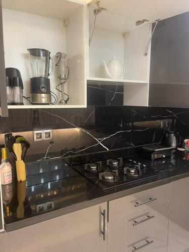 a kitchen with a stove and a counter top at Modern Apartment Airport in Marrakech