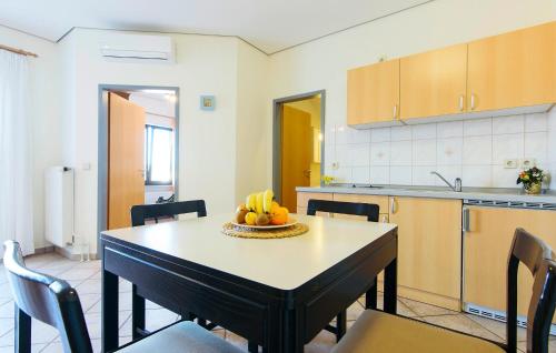 a kitchen with a table with a bowl of fruit on it at Stunning Apartment In Jezera With Wifi in Vrelo Koreničko