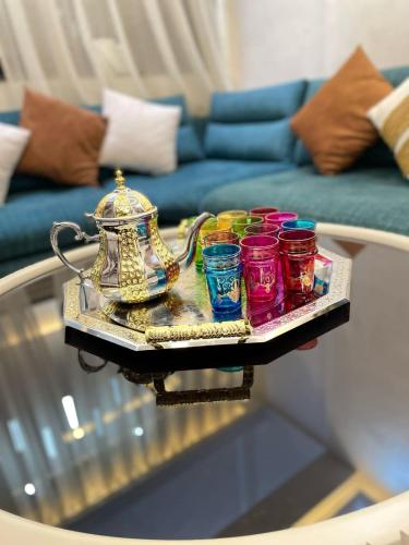 a tray with a tea kettle and cups on a table at Modern Apartment Airport in Marrakech