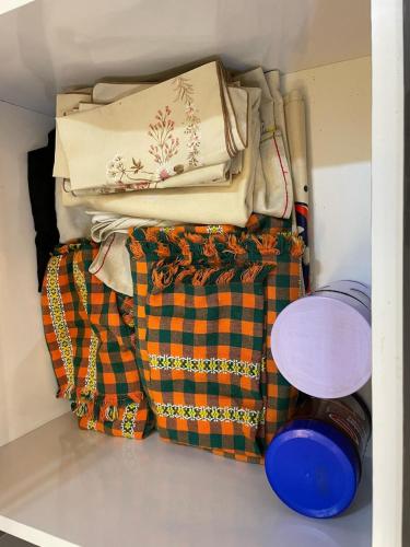 a pile of blankets and other items in a closet at Modern Apartment Airport in Marrakech