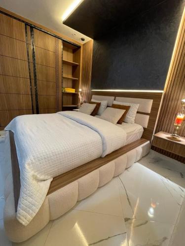 a bedroom with a large white bed in a room at Modern Apartment Airport in Marrakech