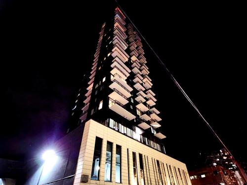 a tall building at night with a street light at Luxurious Downtown condo with spectacular views in Calgary