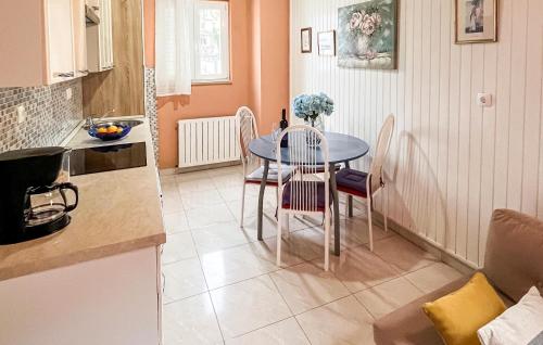 a kitchen with a table and chairs in a kitchen at Stunning Apartment In Supetar With Wifi in Supetar
