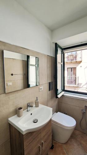 a bathroom with a sink and a toilet and a mirror at Da Nenè in Cefalù