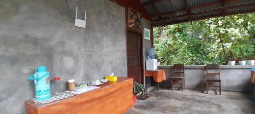 an outside area of a building with a table and chairs at Renny's Tangkoko Safety Stop in Bitung