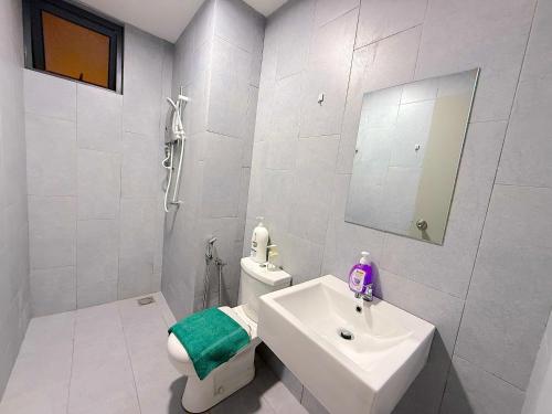a white bathroom with a sink and a toilet at M Vertica Cheras by RASBO Galaxy Suites in Kuala Lumpur