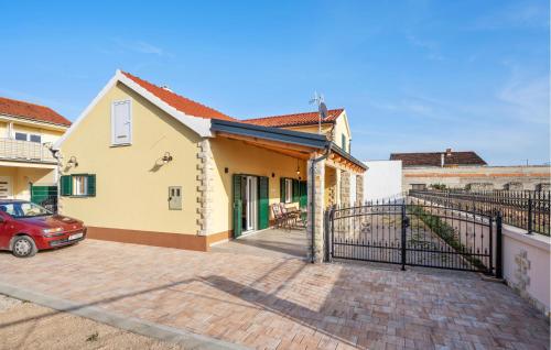 a house with a gate and a car parked in a driveway at 4 Bedroom Stunning Home In Vodice in Vodice