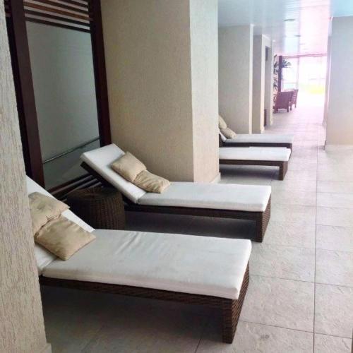 a row of beds sitting in a room at Loft que parece SPA em Belém in Belém