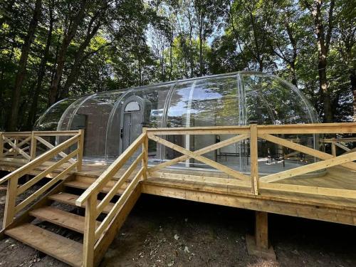 a glass igloo on a wooden deck with a ramp at 2-bedroom Capsule House #30 in Parry Sound