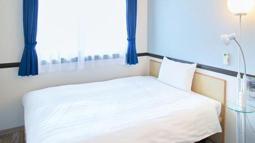 Letto o letti in una camera di Toyoko Inn Nagoya Marunouchi