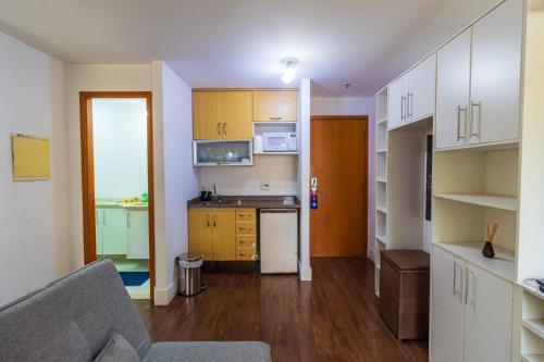 a kitchen with white cabinets and a counter top at LFlats Hotel Alameda Lorena Jardins in Sao Paulo
