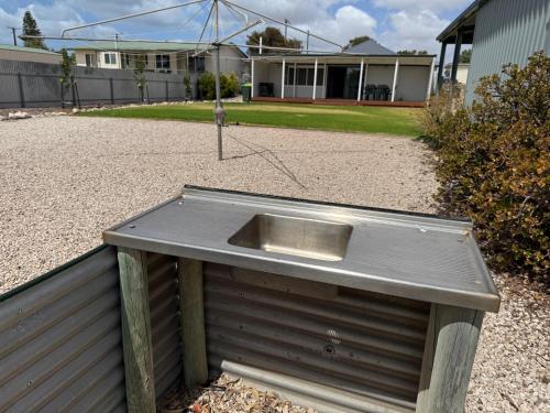 a metal box sitting on top of a fence at Shakona in Port Vincent