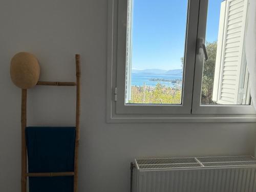 a room with a window and a radiator and a chair at La Vista Residence - 5 BDS, 2 private swimming pools, stunning sea views only 10 minutes from Corfu Town's Centre in Gouvia