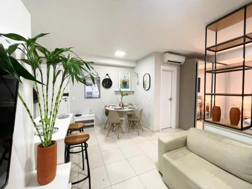 a living room with a couch and a table at Loft que parece SPA em Belém in Belém