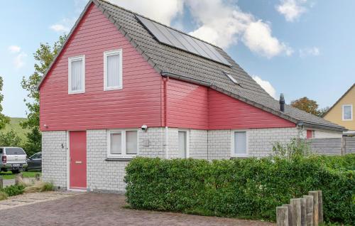 a red and white house with a black roof at Stunning Home In Wemeldinge With Sauna in Wemeldinge