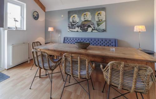 a dining room with a wooden table and chairs at Stunning Home In Wemeldinge With Sauna in Wemeldinge