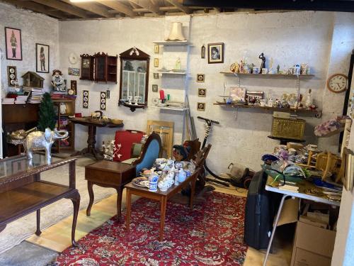 a living room filled with lots of furniture and a table at Country Mill House in Lawrencetown