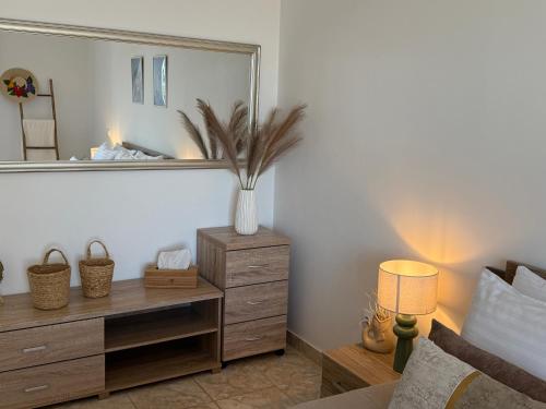 a bedroom with a dresser and a large mirror at La Vista Residence - 5 BDS, 2 private swimming pools, stunning sea views only 10 minutes from Corfu Town's Centre in Gouvia