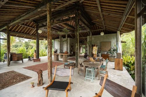 a large outdoor living room with a table and chairs at Desa Seni Baturiti in Baturiti