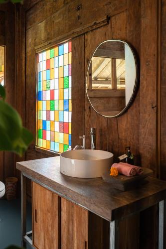 a bathroom with a sink and a mirror at Desa Seni Baturiti in Baturiti