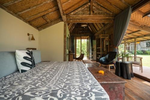 a bedroom with a large bed and wooden ceilings at Desa Seni Baturiti in Baturiti
