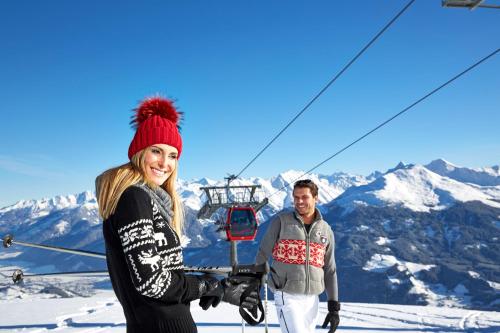 a man and a woman standing on top of a ski lift at Hotel Gasthof Schweizerhaus in Stuhlfelden