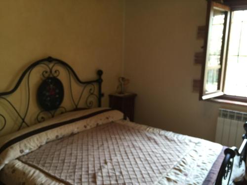 a bedroom with a bed in a room with a window at Azienda Agrituristica I Tre Casali in Magione