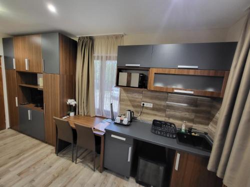 a kitchen with a desk and a counter top at Vén Diófa De Lux Panzió in Szeged