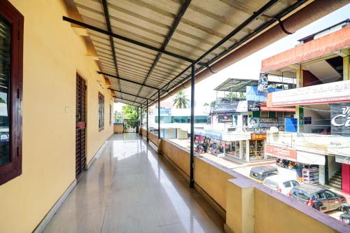 an empty aisle of a grocery store with windows at Hotel O Lekshmi Rooms & Villas in Alleppey