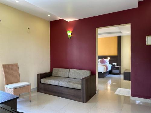 a living room with a couch and a bedroom at The Heights Munnar in Munnar